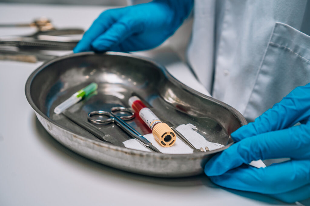 nurse holding a tray surgical and medical waste equipment